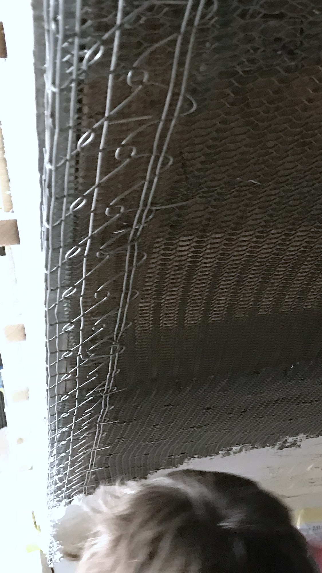 Cal Kote plaster over metal lath on the underside of a spiral staircase, Arch Aid at the edge