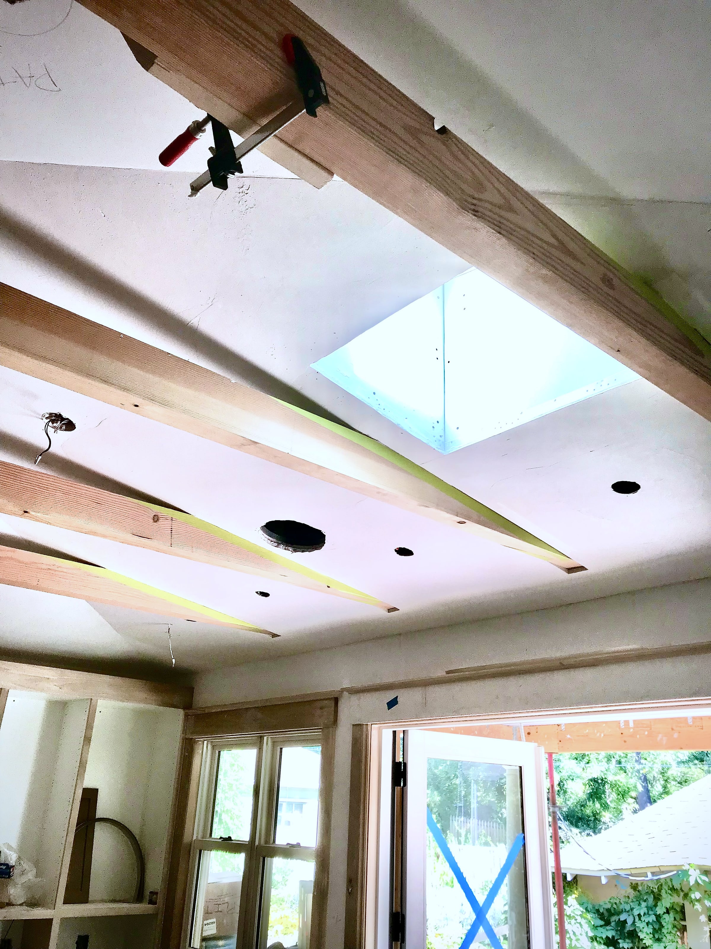 A ceiling with exposed beams, boarded and awaiting Venetian Plaster
