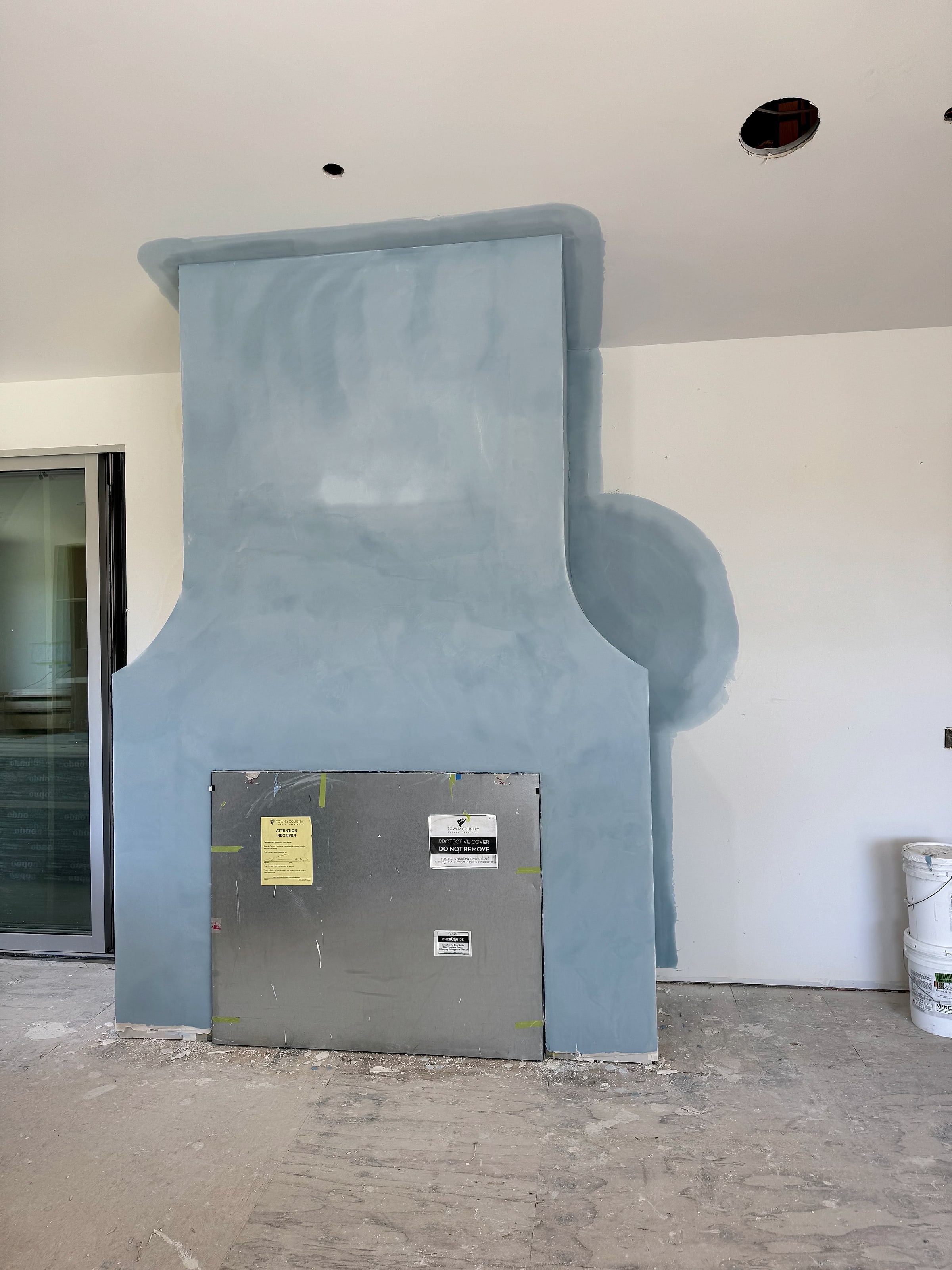 The same fireplace after drywall mud to level five and Venetian Plaster