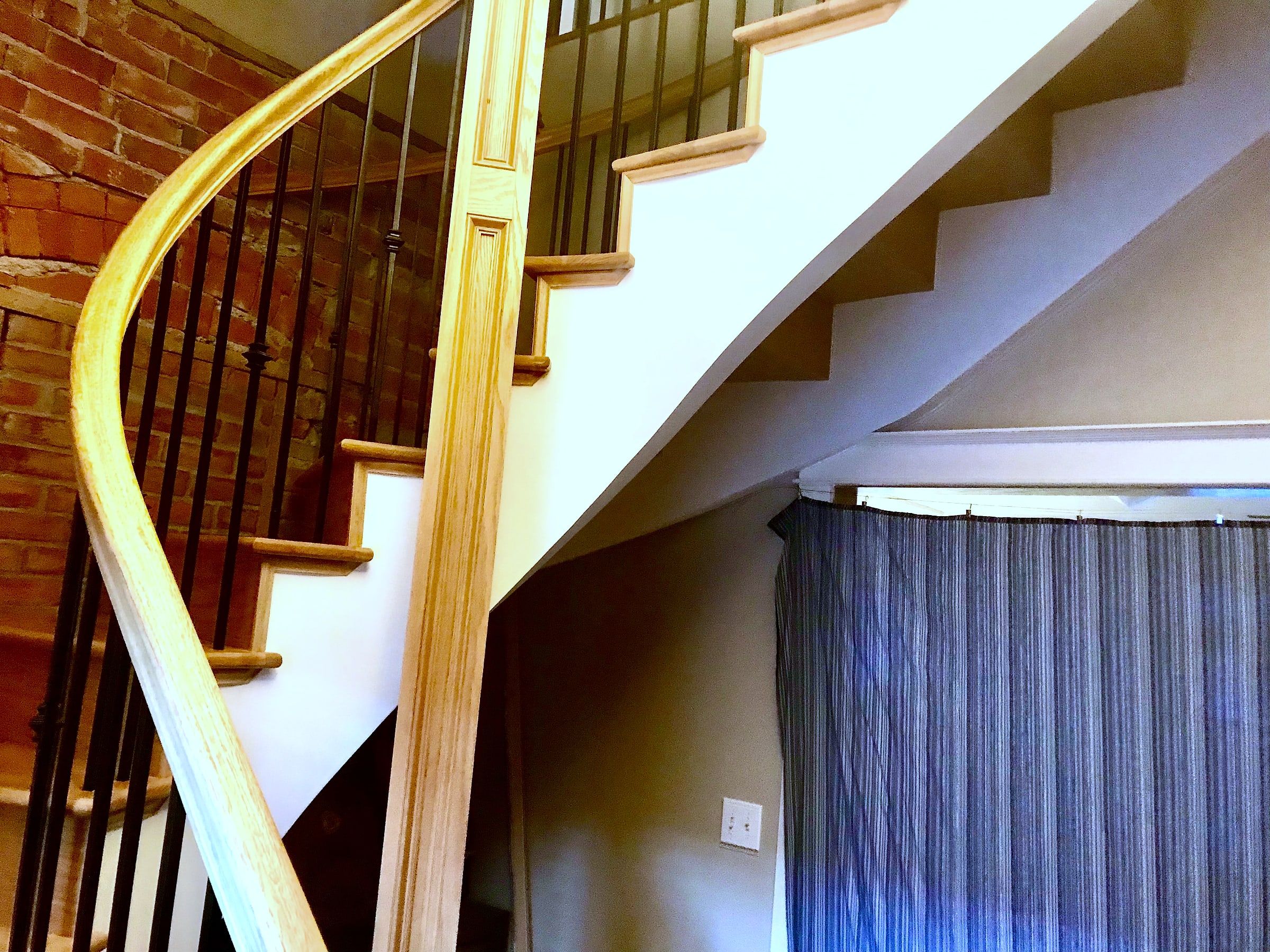 Finished plaster carried around a spiral staircase on Pine Street, Boulder